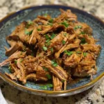 3 ingredient slow cooker pulled pork in a bun with barbecue sauce