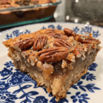 Over-the-top pecan pie dump cake served on a plate