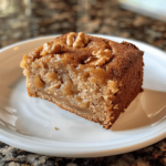 Homemade Amish applesauce cake with walnuts and raisins, large slice on plate