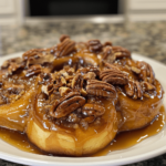 Enormous bourbon pecan sticky buns on a plate, taken with a phone camera