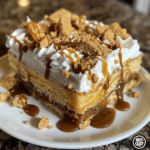 Amateur phone photo of a giant slice of Butterfinger poke cake with whipped topping and crushed Butterfinger bars