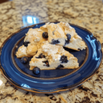 Homemade master scones piled high on a plate, photographed by an amateur