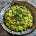Bright green pea purée served in a bowl with mint garnish