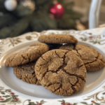 Close-up of chewy molasses crinkle cookies with crackled sugar tops on a baking tray