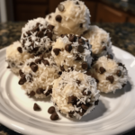 Close-up of homemade no-bake coconut balls made with shredded coconut and chocolate