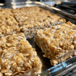 Cinnamon Cottage Cheese Oatmeal Bake sliced into thick squares with a creamy cinnamon-speckled center