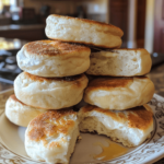 Homemade buttermilk English muffins stacked with nooks and crannies