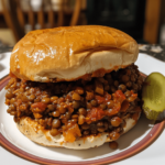 Heaping lentil sloppy joes on toasted buns with pickles