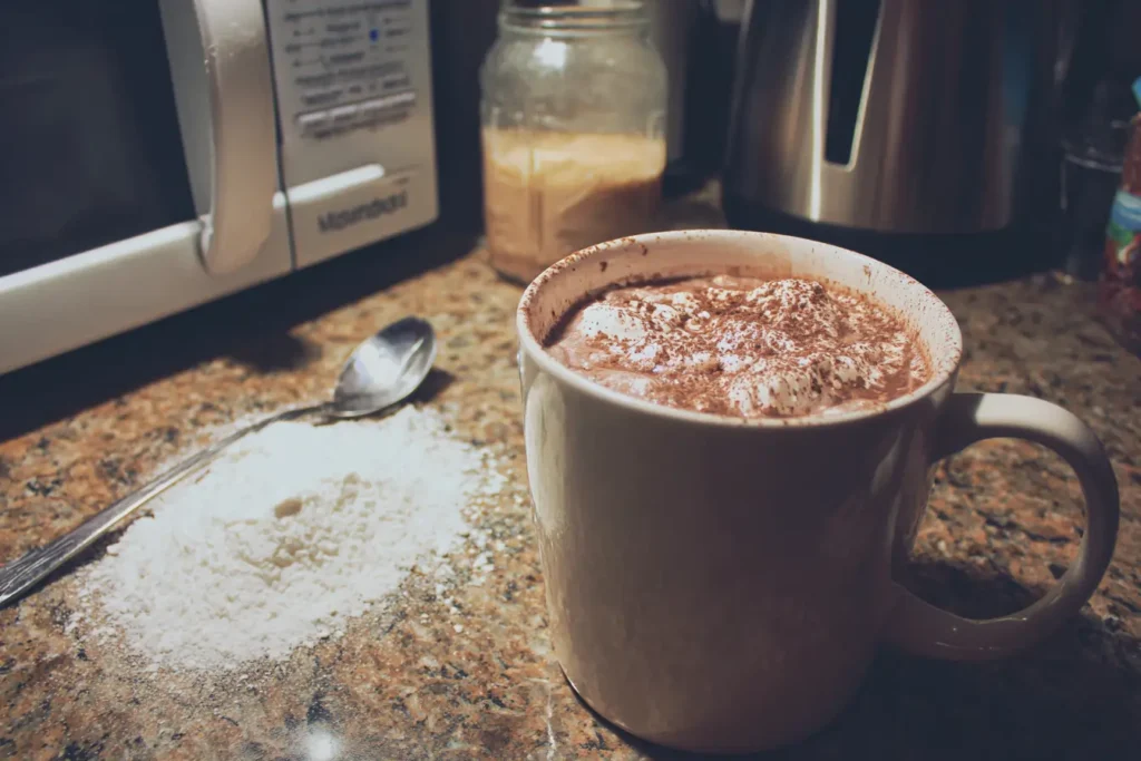 Mug of coconut milk hot chocolate inside microwave