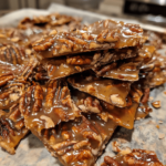 Pecan pie bark pieces on parchment paper