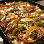 Philly cheesesteak casserole with melted provolone and onions