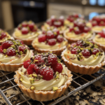 White chocolate mousse tartlets topped with raspberries and pistachios