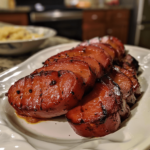 Air fryer kielbasa slices browned and juicy on a plate