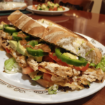 Chicken torta sandwich with chicken, avocado, and chipotle mayo
