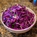 Tangy purple cabbage slaw in a bowl