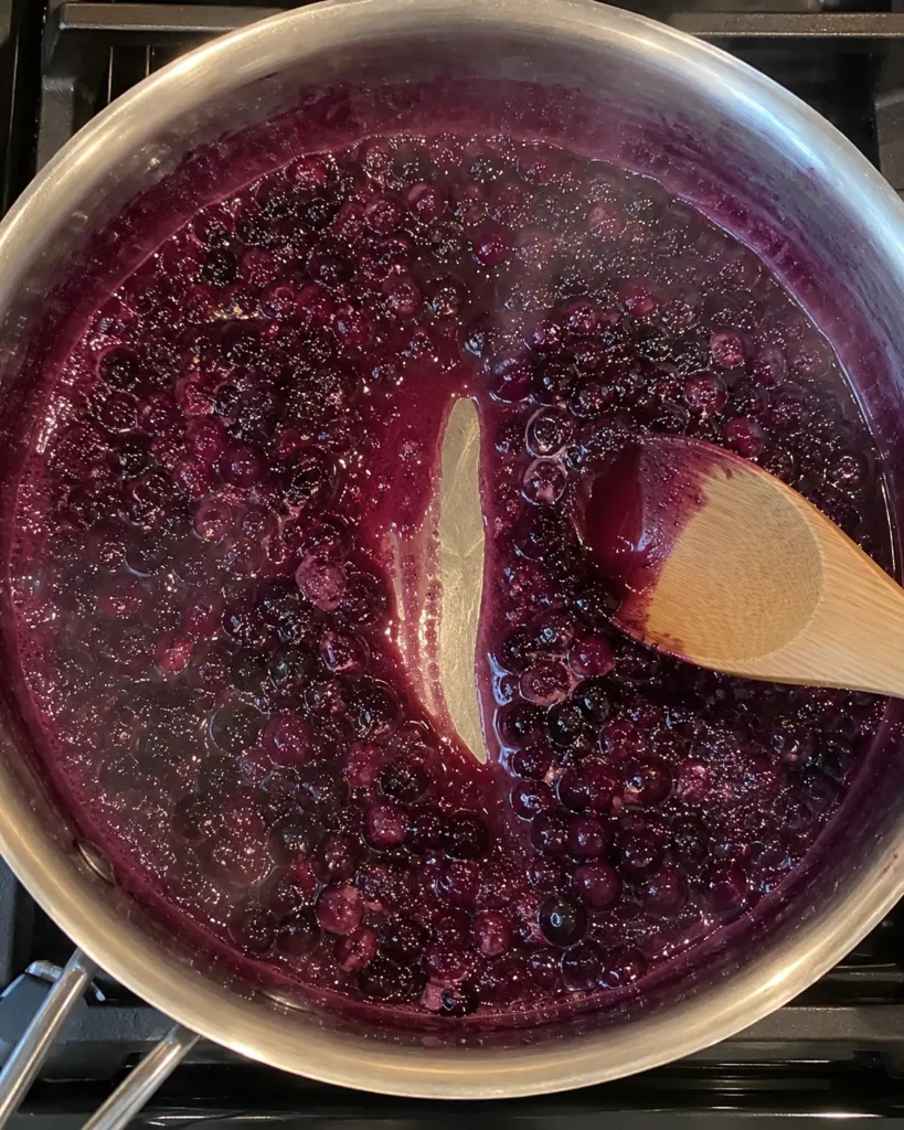 Spoon drag test showing the right thickness for Homemade Huckleberry Sauce