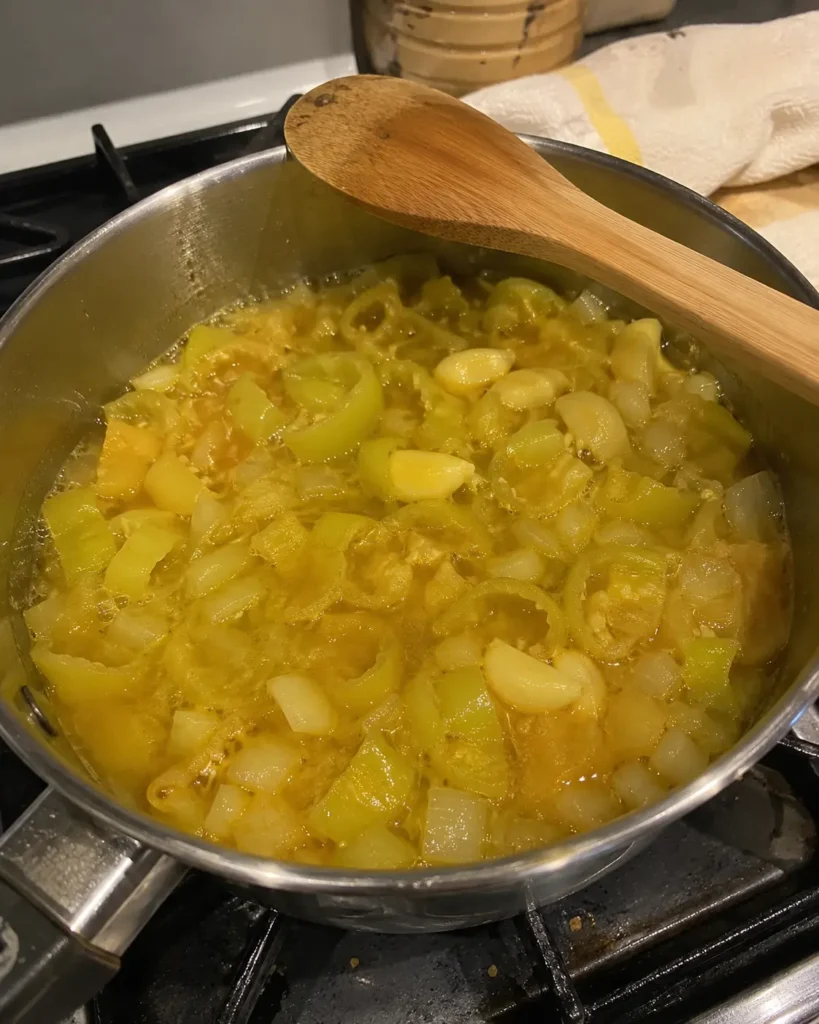 Banana peppers onion and garlic simmering in vinegar for banana pepper hot sauce