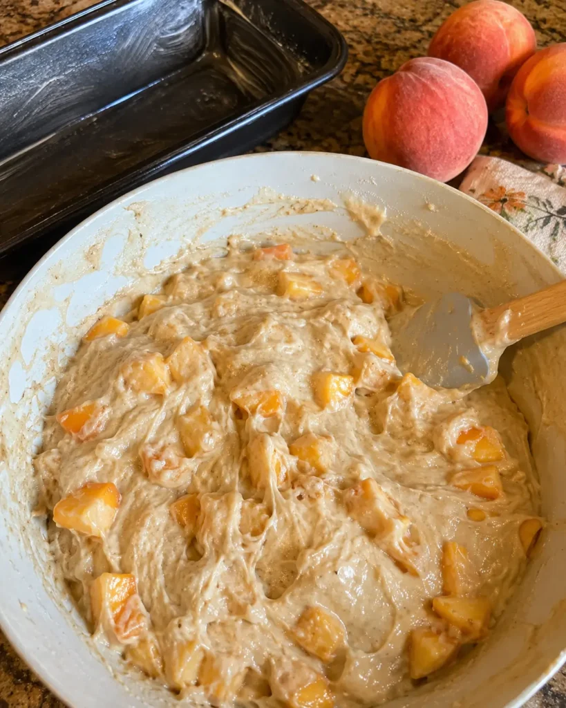 Southern Peach Bread batter with fresh peaches being folded in