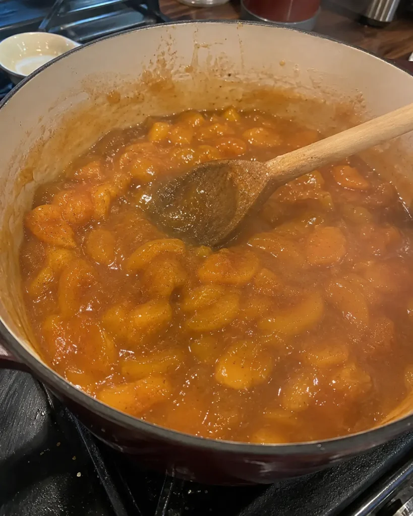 Peaches simmering into Amish Peach Butter in a pot