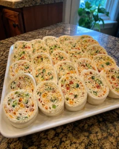 Cheese & Veggie Roll-Ups sliced into pinwheels on a platter