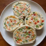 Close-up of Cheese & Veggie Roll-Ups pinwheel slices on a plate