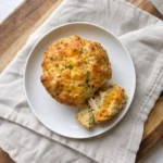 Single Chicken & Cheese Lunchbox Muffin on a small plate with a piece broken off