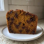 A slice of Chocolate Chip Pumpkin Bread showing the moist interior