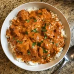 Bowl of Crockpot Butter Chicken with creamy sauce and rice