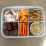 Overhead view of a DIY Snacky Lunch Box with all ingredients visible