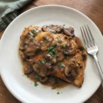 Plated Chicken Marsala garnished with fresh parsley