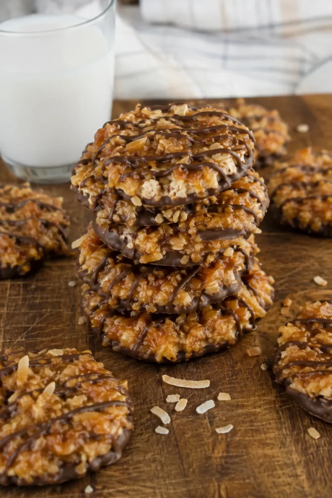 Stack of No-Bake Samoa Cookies on a wood board with a glass of milk