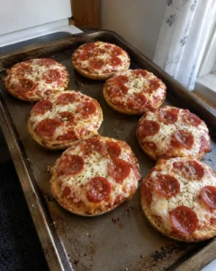 English Muffin Pizzas fresh out of the oven with melted cheese