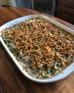 Green Bean Casserole topped with crispy fried onions in a baking dish