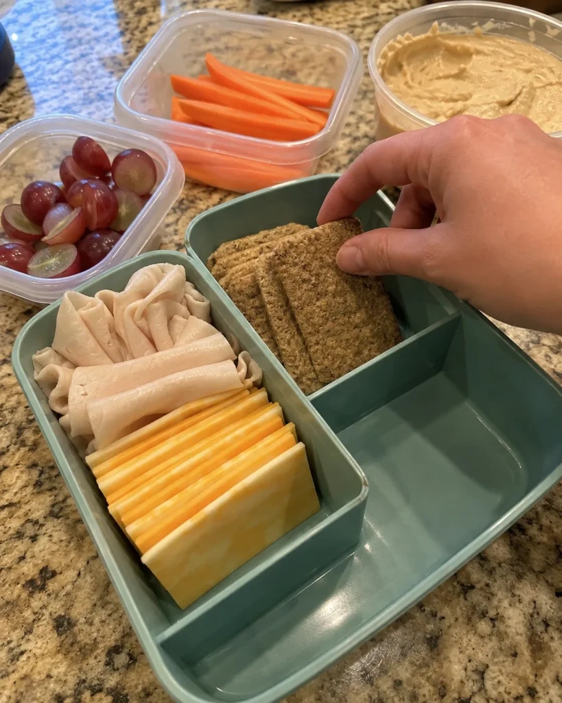 Filling compartments while assembling a DIY Snacky Lunch Box
