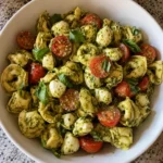 Close-up of Easy Pesto Tortellini Pasta Salad with pesto and mozzarella pearls