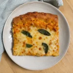 A slice of Pumpkin Ricotta Flatbread on a plate