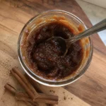 Close-up of Slow Cooker Apple Butter in a jar with a spoon