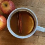 Overhead view of Slow Cooker Apple Cider with cinnamon and orange