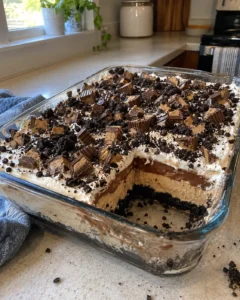 No Bake Chocolate Peanut Butter Oreo Dessert in a 9×13 pan with visible layers and crushed Oreo topping